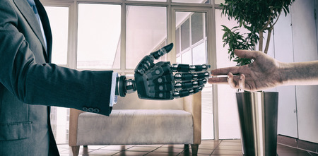 Cropped hand of woman against sofa chair in the officeの写真素材