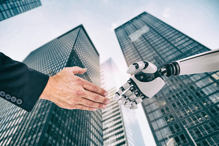 Businessman holding his hand out against skyscraperの写真素材