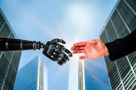 Hand presenting against skyscrapersの写真素材