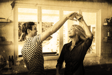 Grey background against cute couple dancingの写真素材