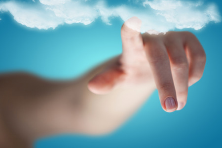 Cropped image of woman hand pointing against blue vignette backgroundの写真素材