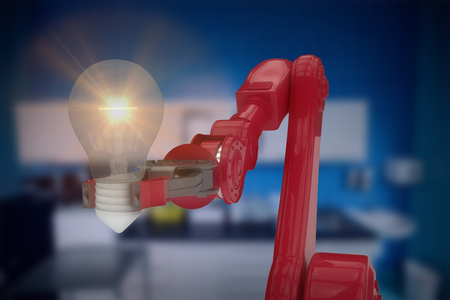 Composite image of robotic arm holding light bulb against counter arena 3dの写真素材