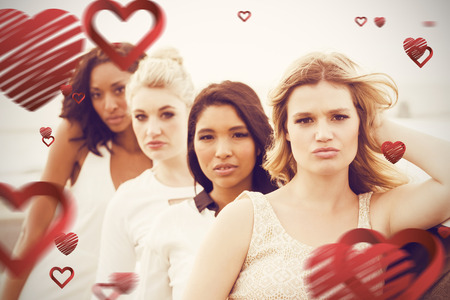 Portrait of female friends posing while leaning on limousine against love heart patternの写真素材