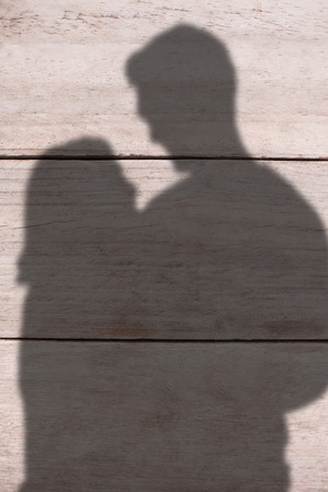 Attractive couple flashing their cash against wood panellingの写真素材