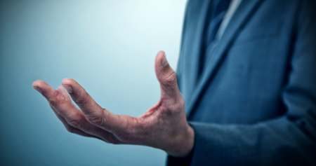 Midsection of elegant businessman against grey vignette