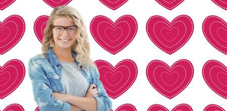 Portrait of smiling businesswoman wearing eyeglasses with arms crossed  against valentines day...