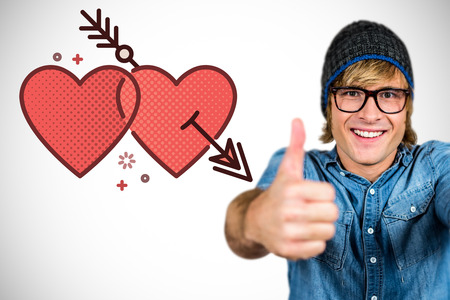 Smiling hipster with thumbs up against white background with vignetteの写真素材