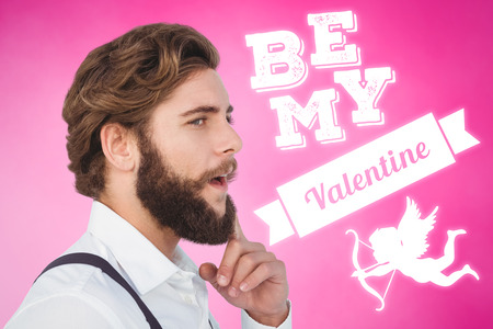 Thoughtful hipster with finger on chin against pink backgroundの写真素材