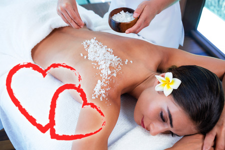 woman enjoying salt scrub massageの写真素材