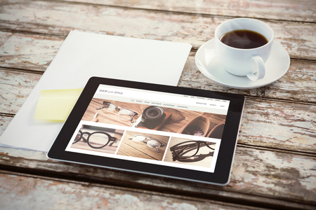 vintage glasses  against overhead of tablet on deskの写真素材
