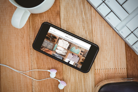 shop with style homepage against black smartphone with cup of coffeeの写真素材