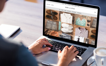 shop with style homepage against cropped image of man working on laptopの写真素材