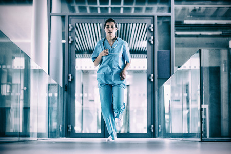 Nurse running in hospital corridor during emergencyの写真素材