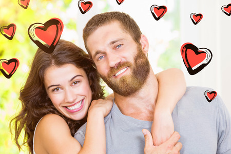 Red Hearts against portrait of young couple embracingの写真素材