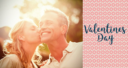 valentines words against wife kissing husband on cheekの写真素材