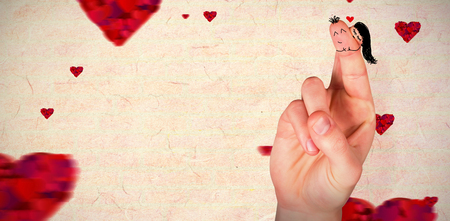 Fingers crossed like a couple against love heart patternの写真素材