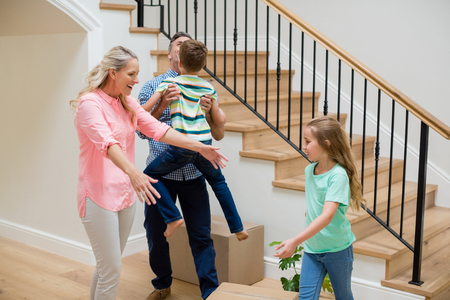 Parents and kids having fun in living room at homeの写真素材