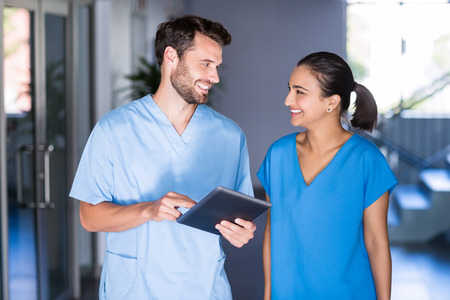 Doctors using digital tablet in hospitalの写真素材