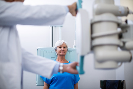 Senior woman undergoing an x-ray test in hospitalの写真素材