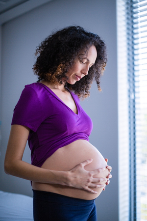 Pregnant woman standing in ward of hospitalの写真素材