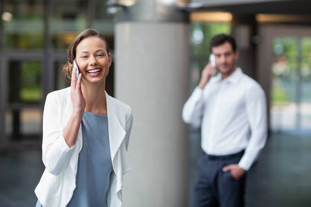 Portrait of a happy businesswoman talking on mobile phoneの写真素材