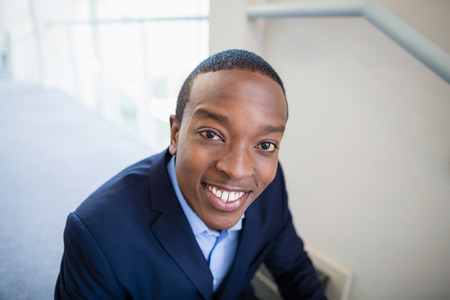 Portrait of a businessman smiling at conference centreの写真素材
