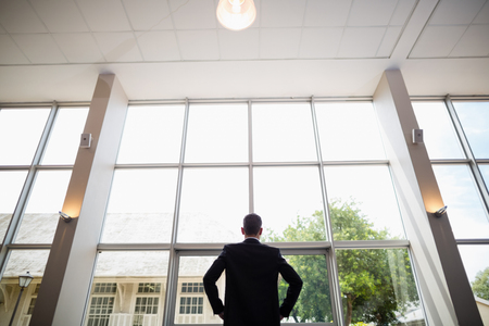 Rear view of a businessman standing in conference centreの写真素材