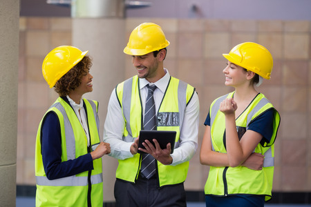 Architects discussing over digital tablet at conference centreの写真素材