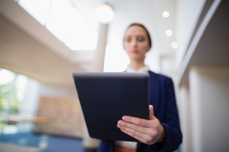 Businesswoman using digital tablet at conference centre