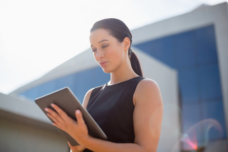 Businesswoman using digital tablet outside the conference centreの写真素材