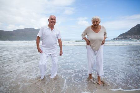 Happy senior couple having fun together at beachの写真素材