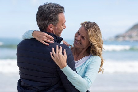 Romantic mature couple embracing each other on the beachの写真素材