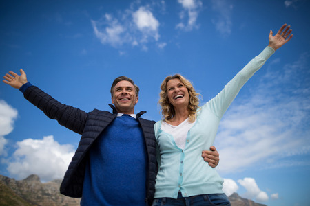Smiling mature couple enjoying on the beachの写真素材