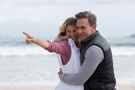 Romantic mature couple embracing each other on the beachの写真素材