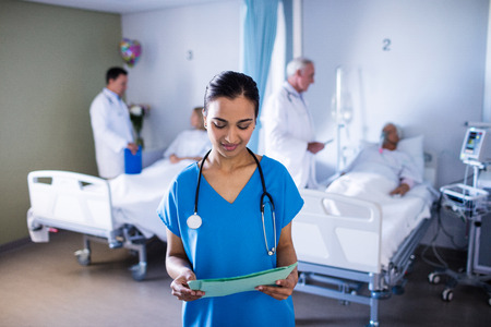 Female doctor looking at a file in the hospital