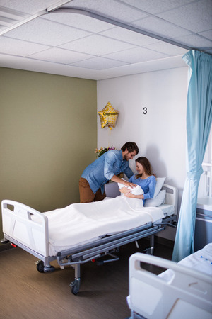 Couple with their new born baby in the ward at the hospitalの写真素材