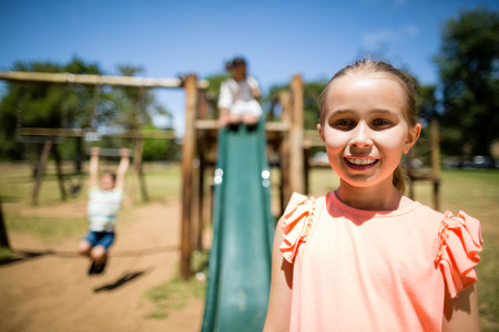 Portrait of innocent girl smiling in a park on a sunny day