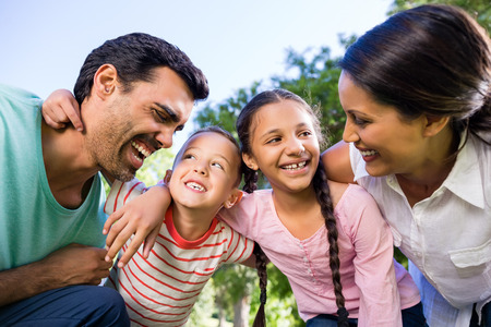 Happy family enjoying in park on a sunny dayの写真素材