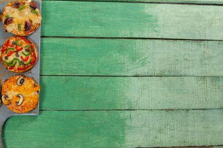 Various delicious italian pizza served in pizza tray on wooden plankの写真素材