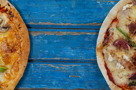 Overhead of italian pizza served on wooden plankの写真素材