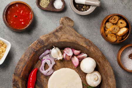 Ingredient with pizza dough in wooden bowlの写真素材
