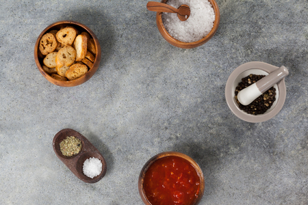 Ingredients, tomato sauce and toast in bowl on grey backgroundの写真素材