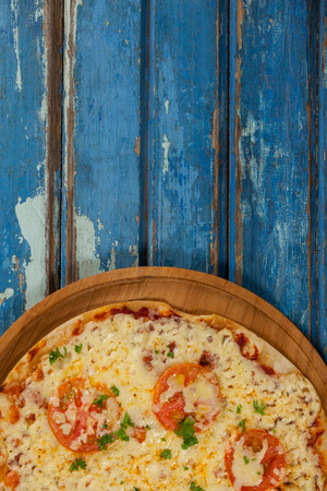 Close-up of delicious italian pizza served on pizza trayの写真素材