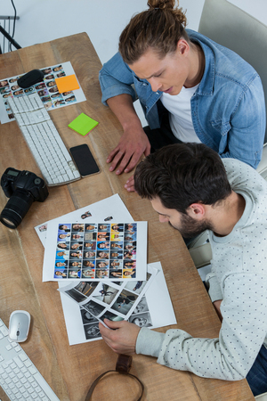 Photographers working together at desk in officeの写真素材