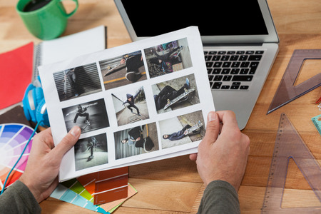 Close-up of photographer working at desk in officeの写真素材