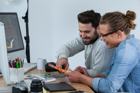 Photographers working together at the desk in officeの写真素材