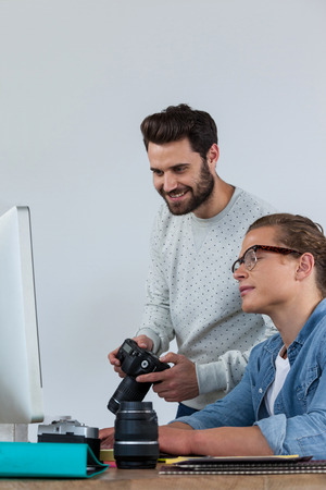 Photographers working together at the desk in officeの写真素材