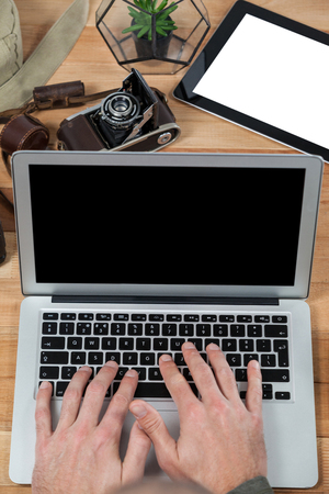 Photographer working over laptop in studioの写真素材