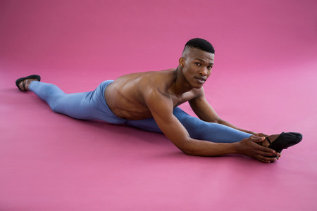 Portrait of ballerino performing a split in the studioの写真素材