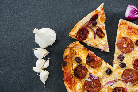Overhead view of italian pizza with various ingredients and salamiの写真素材